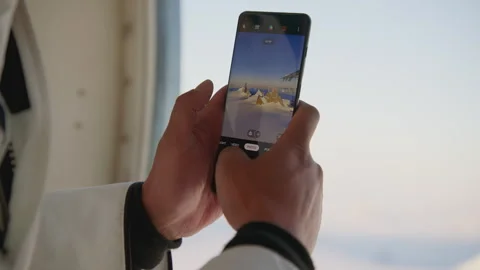 Capturing breathtaking moments with a mobile phone during a flight Stock Footage 288201640