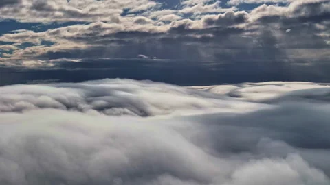 Capturing of dark textured clouds over thick layer of fluffy clouds. Dramatic Video stock 303955069