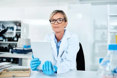 Capturing data with utmost ease. Portrait of a mature scientist using a digital 스톡 사진