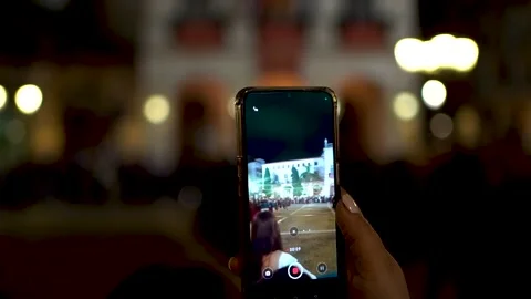 Capturing Easter procession in Gandia on smartphone during night festivities Stock Footage 295014867