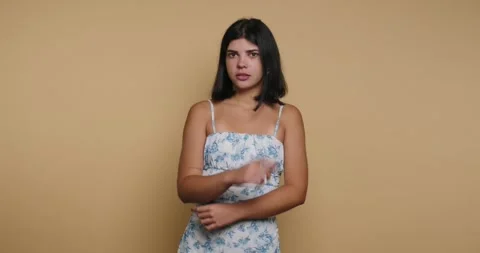 Capturing emotions through expressions in a delicate floral dress against a.. Video stock 329109885