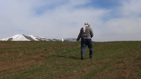Capturing farmers as they spread grain seeds across, stock footage. Stock Footage 304865808