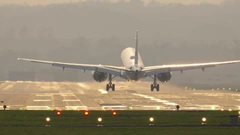 Capturing the graceful touch down of a passenger plane at the airport Stock Footage 332576095