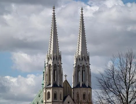 Capturing majestic ascent of gothic structures against turbulent cloud form.. Stockfoto's