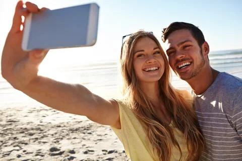Capturing memorable moments. an affectionate young couple taking a selfie on the Stock Photos