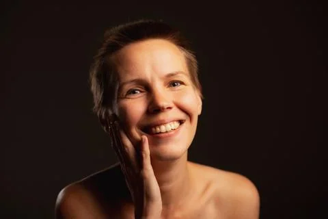 Capturing a middle-aged lady, short-haired, baring her shoulders, sporting .. Stock Photos
