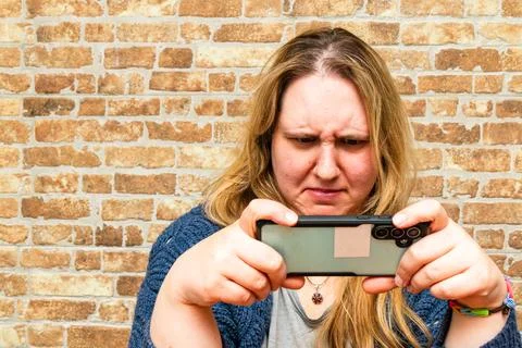 Capturing a moment of concentration with a smartphone in a cozy indoor settin Stock Photos