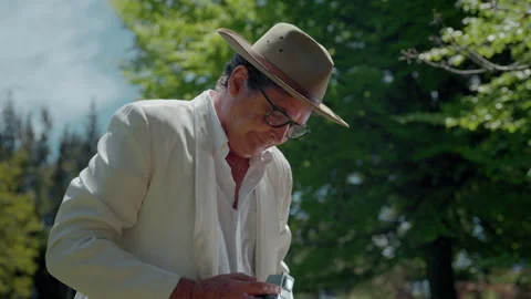 Capturing moments with an analog camera in a serene park setting Stock Footage 321370280