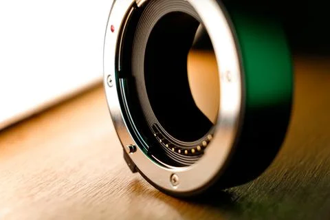 Capturing moments with a beautifully designed camera lens on a warm table 库存照片