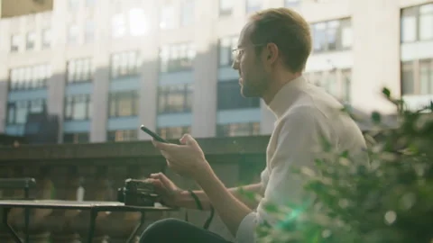 Capturing moments on the street while interacting with a smartphone Stock Footage 312589409