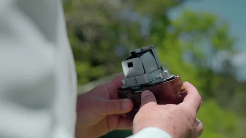 Capturing nature's beauty with an analog camera among the trees Stock Footage 321375937