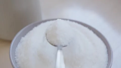 Capturing simple beauty of sugar spooning on kitchen countertop. Vidéo 329153734