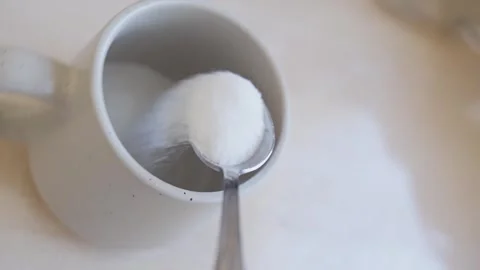 Capturing simple beauty of sugar spooning on kitchen countertop. Video stock 330771562