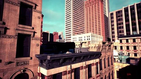 Capturing the tops of skyscrapers at dusk in a bustling metropolis Ilustración de archivo