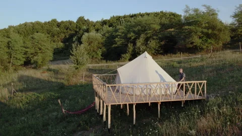 Capturing video with drone birds eye view at the campsite amazing big tents one Stock Footage 243118920