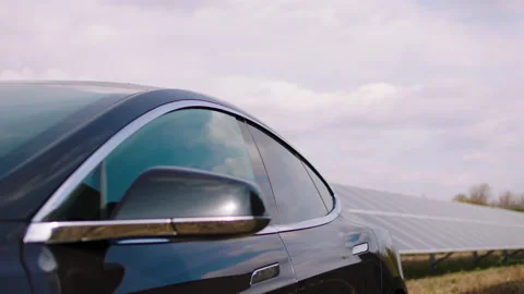 Capturing video of electric car and photovoltaic batteries in a large solar Video stock 169081774