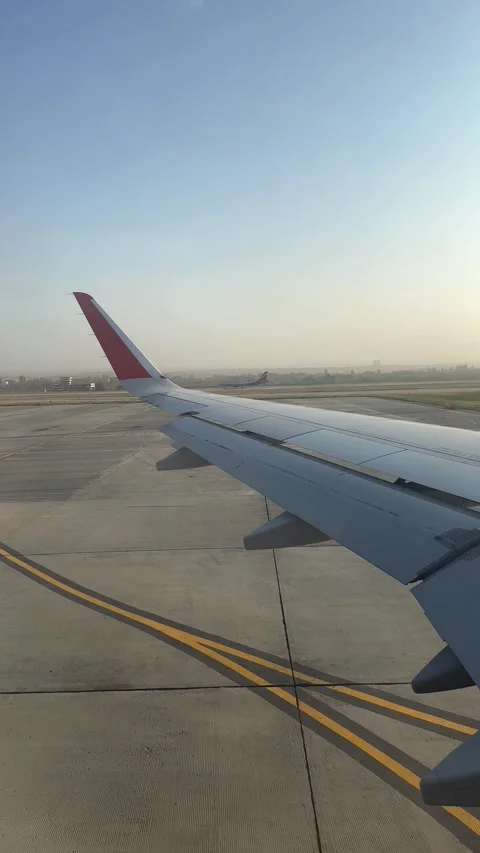 Capturing the view from the aircraft window, another plane taking off  Stock Footage 305599728