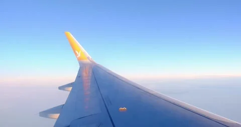 Capturing the wings of an airplane above the clouds Stock Footage 260818838