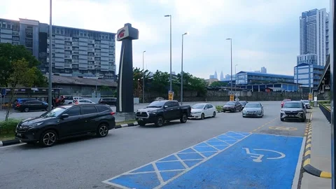 The car is about to stop in the blue-marked area for handicapped people outside Stock Footage 344186556