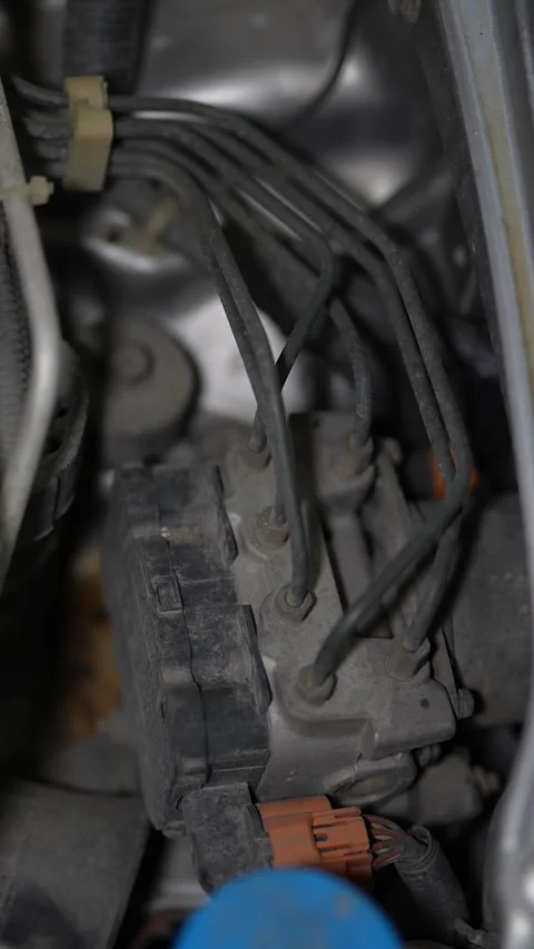 Car ABS hydraulic modulator pump block with connected brake lines. Stock Footage 344365885