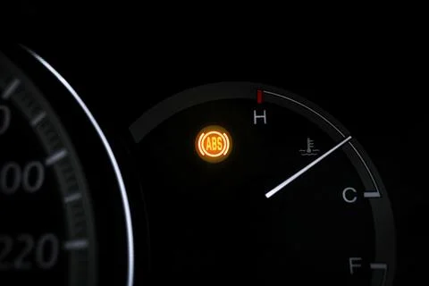 Car ABS warning light blinking on car dashboard Foto stock