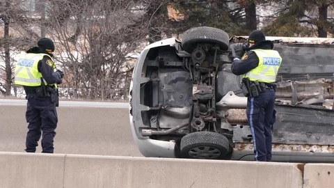 Car accident and rollover crash on busy highway with police officers at scene Stock Footage 86010725