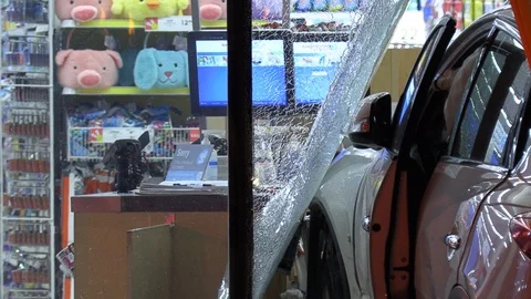Car accident with vehicle into store window Stock Footage 104530678