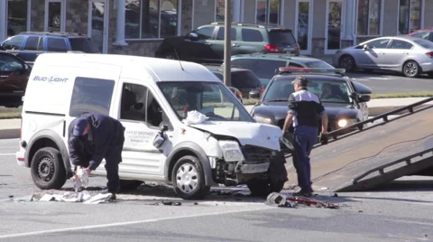 Car accident victim throwing smashed car parts into destroyed car. Stock Footage 61398824