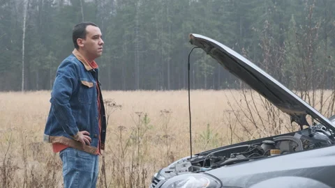 Car accident. Young man looking at at engine. Stock Footage 144064848