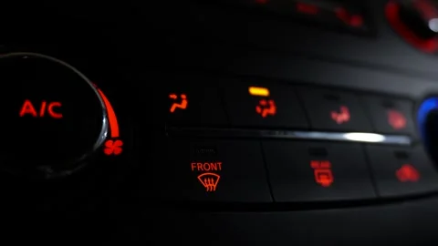 Car air conditioning control panel and defrost buttons illuminated at night Video stock 335722466