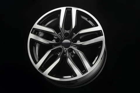 Car alloy wheel, powerful wheel design, split spokes color black with polished Stock Photos