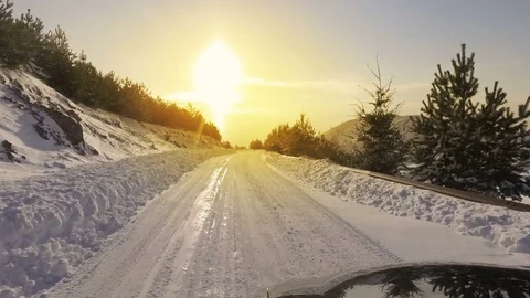 Car and falling snow in winter on forest road with much snow Stock Footage 76173486