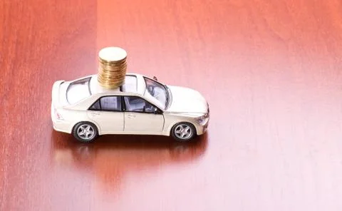 Car and stack of coins Stock Photos