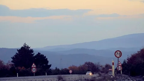 Car And Two Cyclists Moving On The Highway In The Evening Stock Footage 82966471