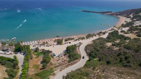 Car approaching Paradise Beach, Kos, ascending aerial shot Stock Footage 162949136