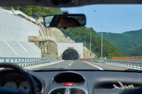 Car approaching a tunnel Stock Photos