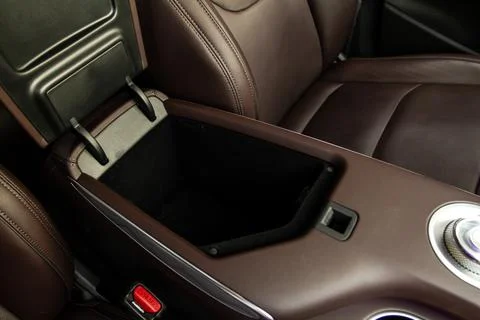 Car armrest opened. Opened armrest in the car for driver. Stock Photos