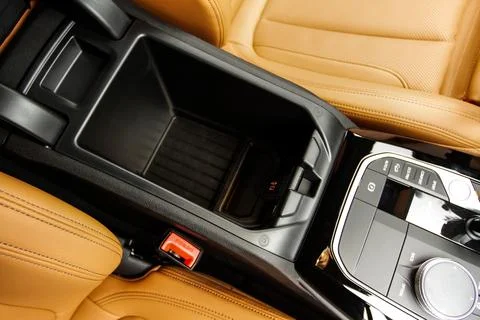 Car armrest opened. Opened armrest in the car for driver. Stock Photos