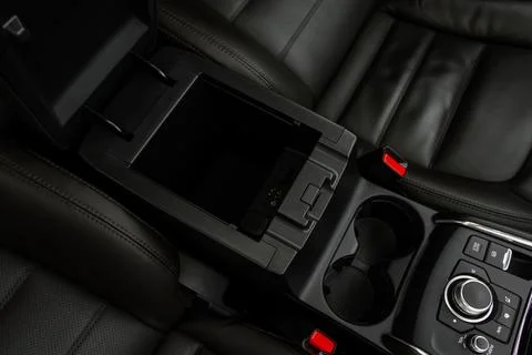 Car armrest opened. Opened armrest in the car for driver. 스톡 사진