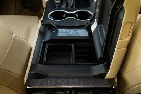 Car armrest opened. Opened armrest in the car for driver. Stock-Fotos
