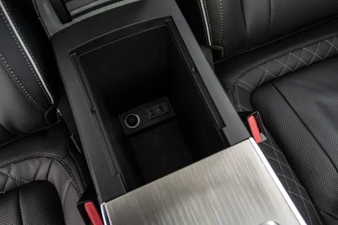 Car armrest opened. Opened armrest in the car for driver. Stock Photos