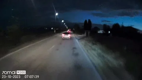 Car Attempts a Dangerous Overtake on Two-Way Street, Verona, Italy - 23 Oct 2023 Stock Footage 326830619