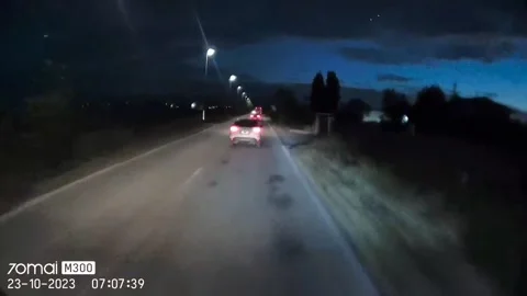 Car Attempts a Dangerous Overtake on Two-Way Street, Verona, Italy - 23 Oct 2023 Stock Footage 326830620
