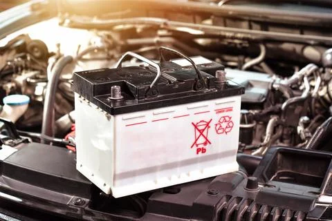 Car battery placed on car engine compartment Stock Photos