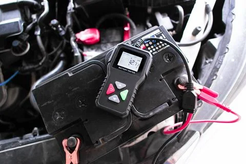 Car battery voltage testing with battery tester 스톡 사진