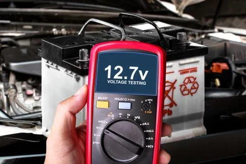 Car battery voltage testing , Voltage testing with multimeter on car battery Stock Photos