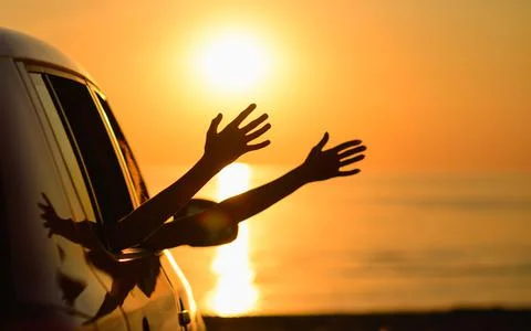 The car is on the beach at sunset. Stock Photos