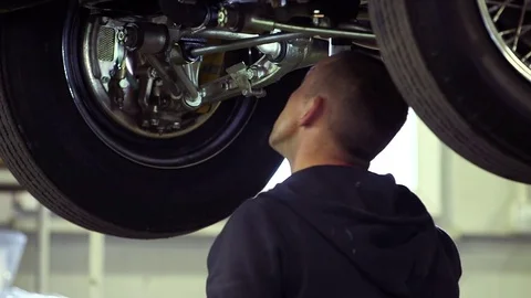 Car Being Restored by a Mechanic. Checking Condition of the Chassis Stock Footage 72706711