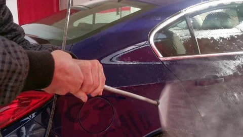 A car is being washed with a hose Stock Footage 275820913