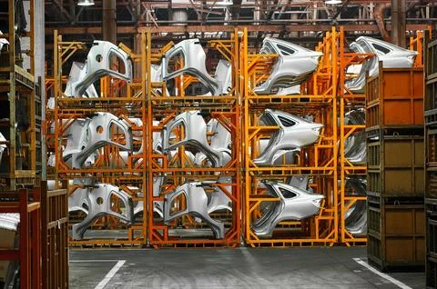 Car body elements on rack in production plant storehouse Stock Photos